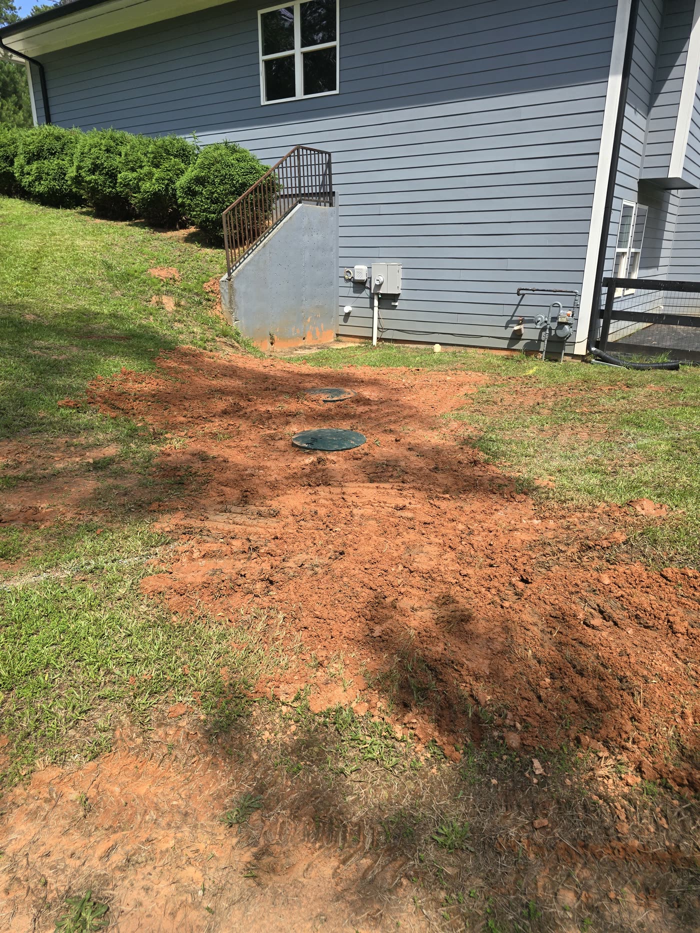 Completed septic install with lids at grade — North Georgia