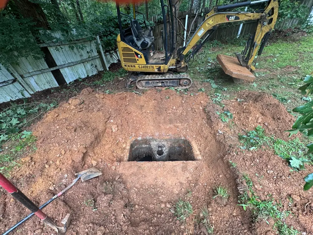 Older concrete septic tank uncovered for service