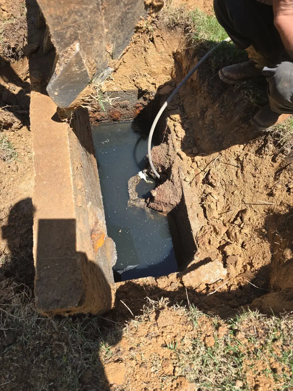 Septic tank opened and being pumped out