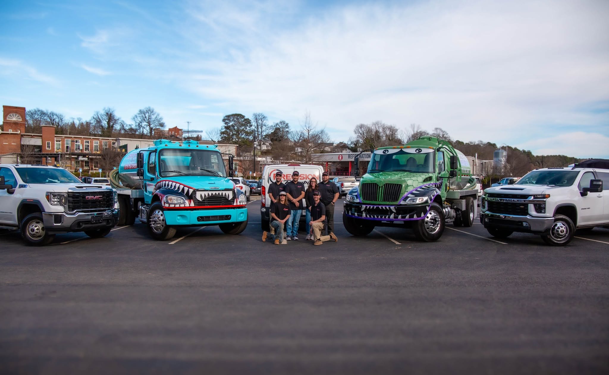 Precision Plumbing & Septic crew with service trucks