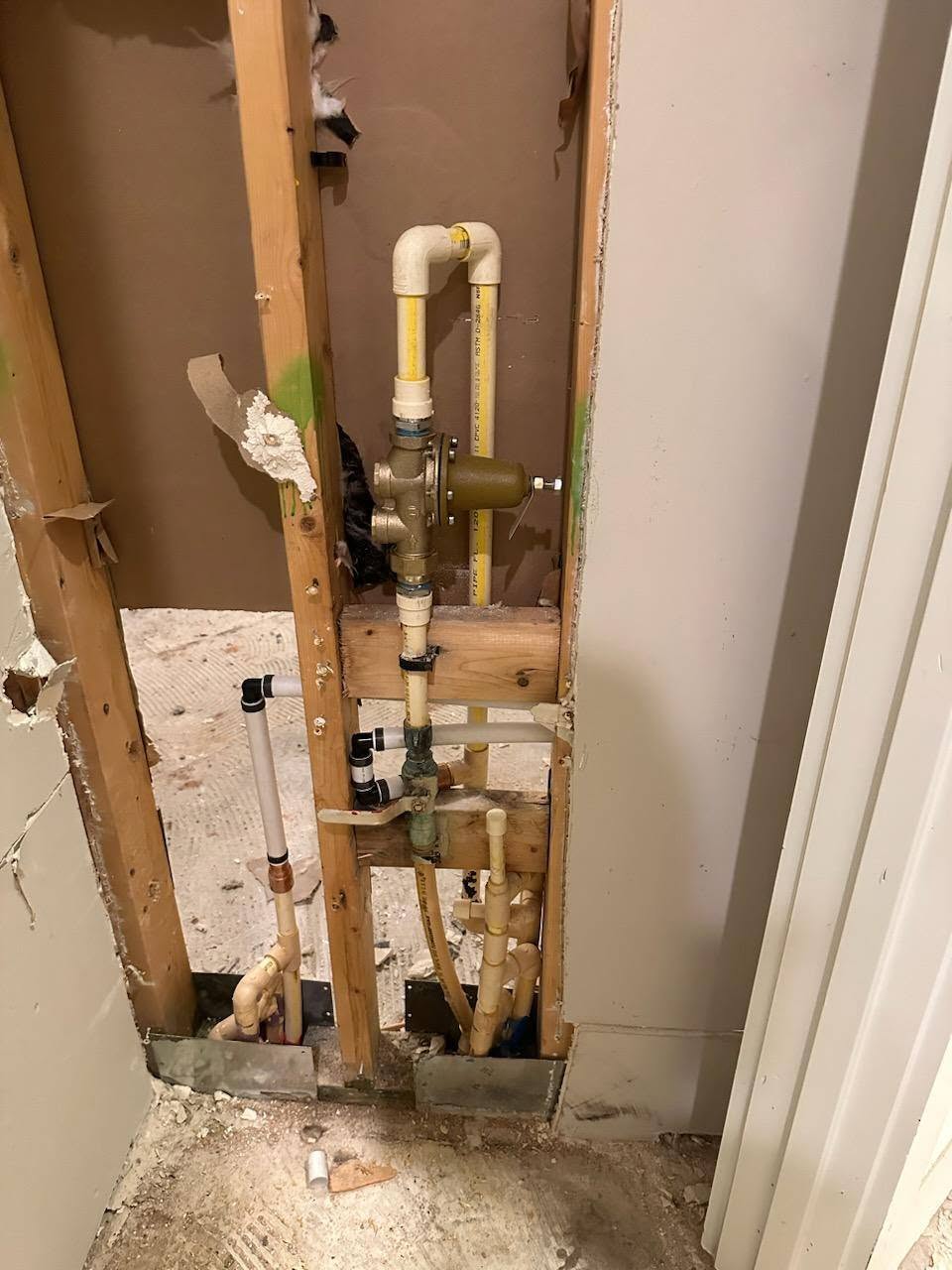 Water line, pressure-reducing valve, and PEX exposed in a wall cavity