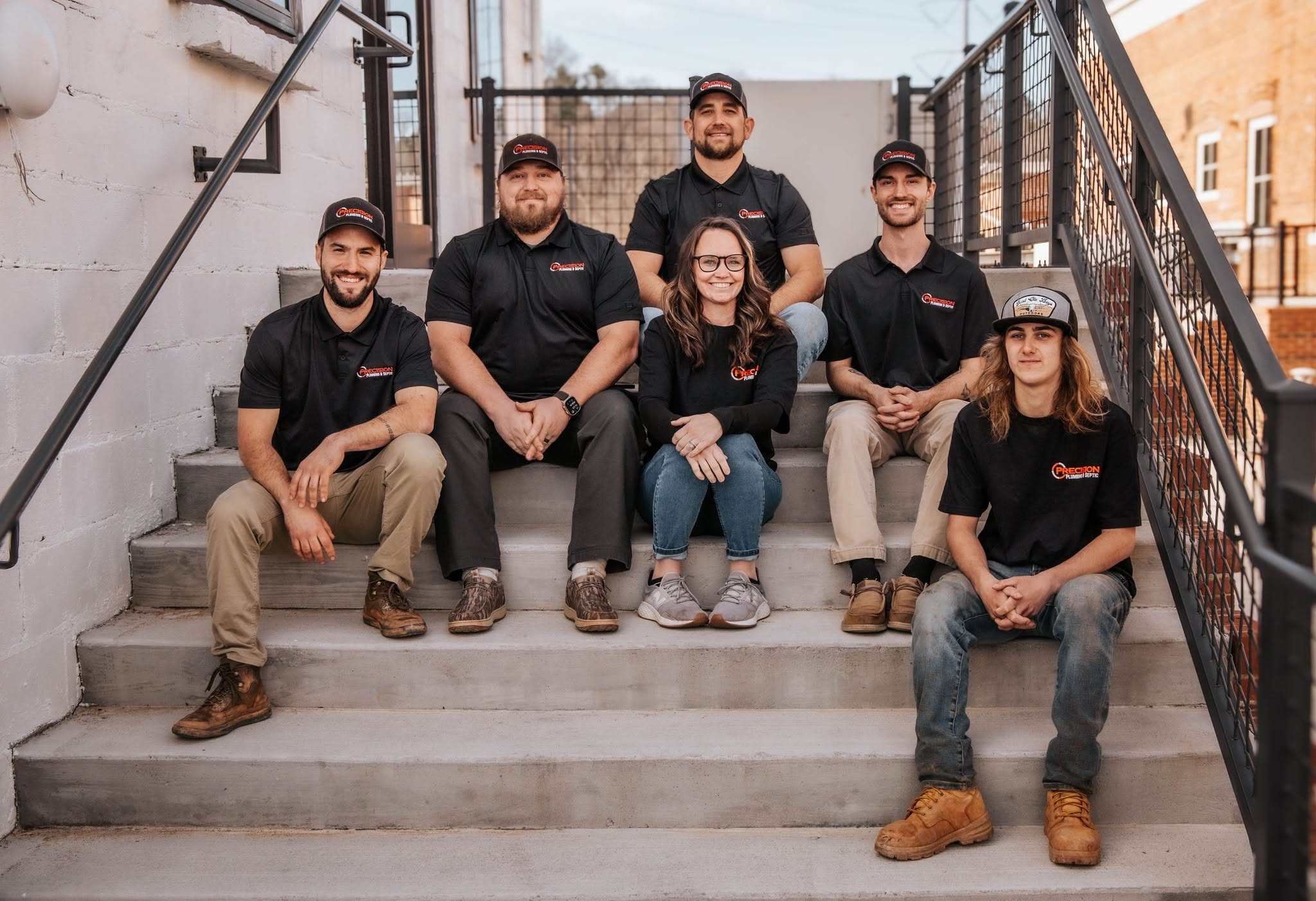 Precision Plumbing & Septic crew on the shop steps in Canton, Georgia
